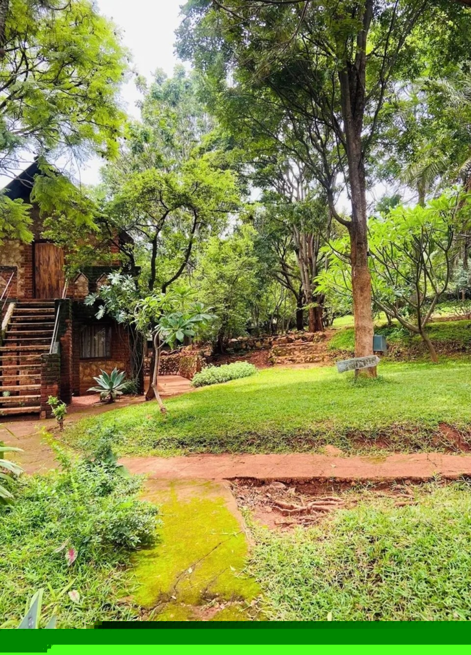 Stone chalet nestled in green gardens at Deans Hill View Lodge